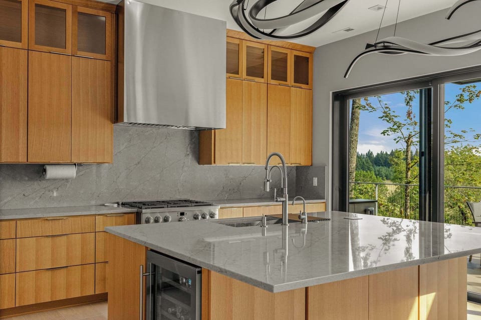 Modern kitchen with island, built in pizza oven, microwave, oven, fridge, drink drawers, wine fridge, dedicated ice machine and gas range. A kitchen for a true chef. Espresso machine, coffee maker and kettle as well.
