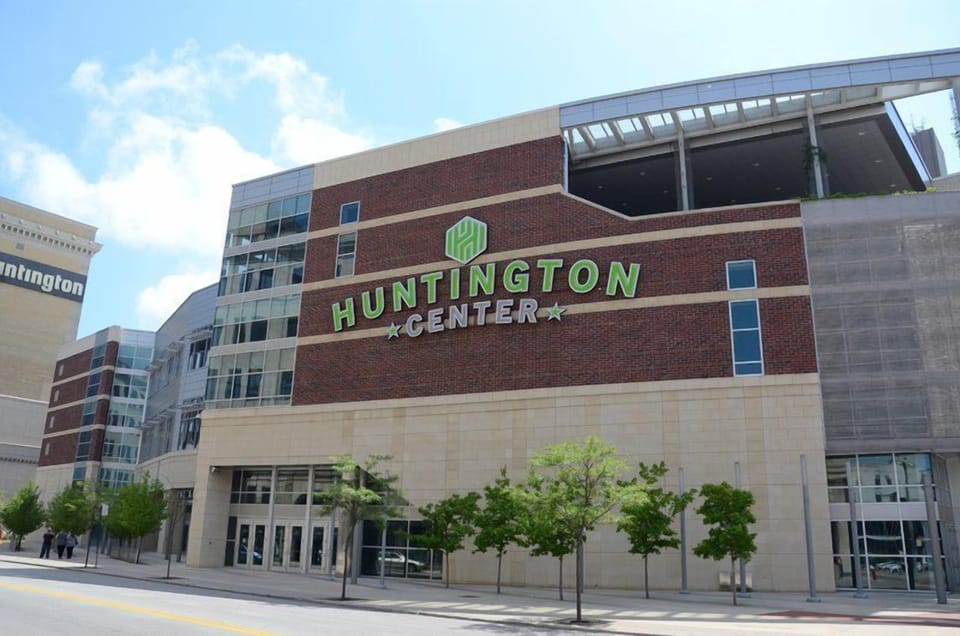 Huntington Center building exterior with brick facade, green signage, and tree-lined sidewalk