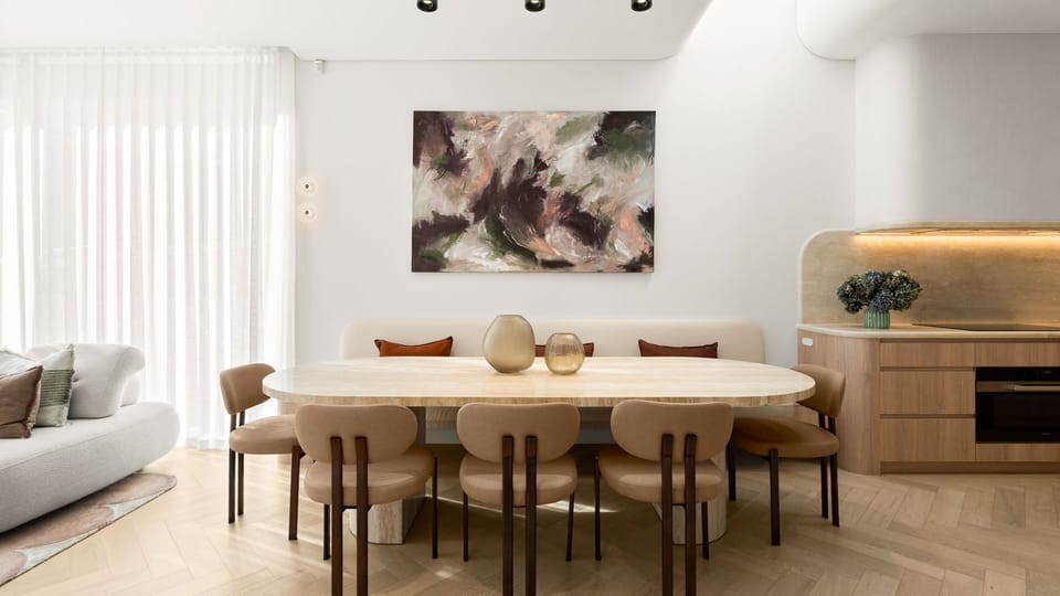 Elegant open-plan dining flowing into the designer kitchen.
