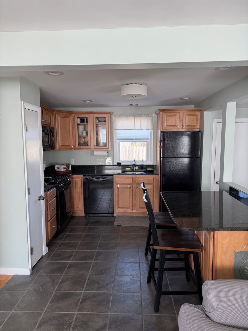 Full kitchen and counter with stools 