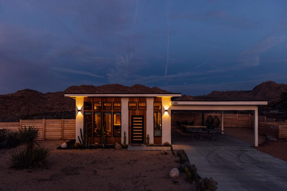 Striking modern retreat glowing under the desert night sky.