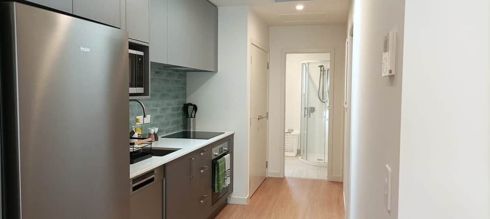 washer, dryer and hot water heater are inside of the door next to kitchen.