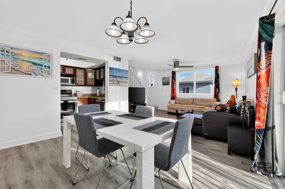 Dining area for four with balcony access and bright natural light.