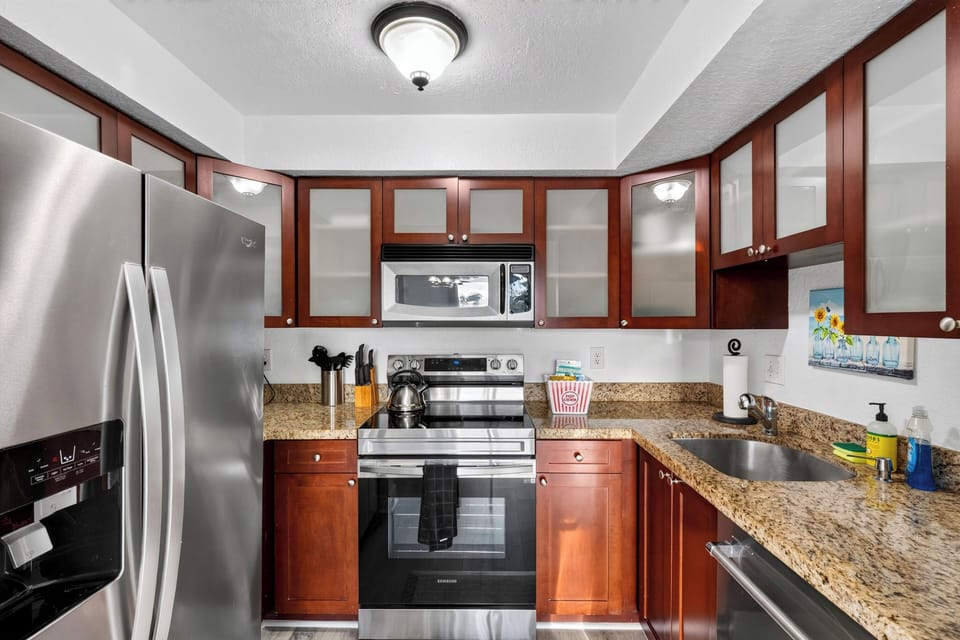 Full kitchen with granite counters, stainless appliances, and everything needed for easy meals at home.
