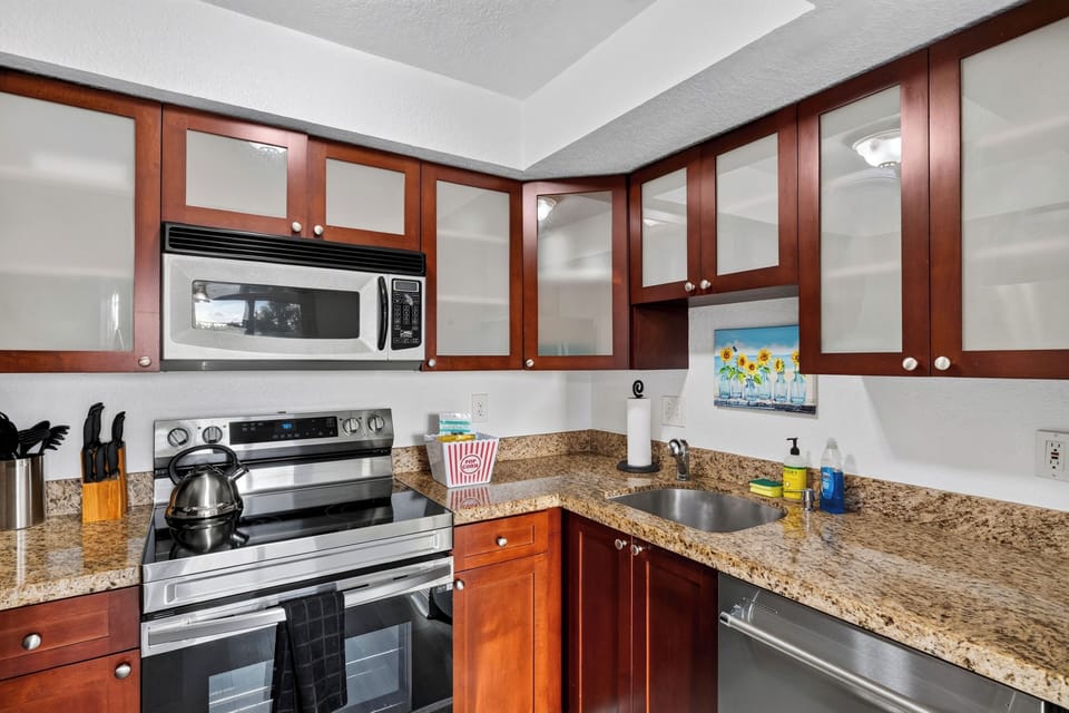 Full kitchen with granite counters, stainless appliances, and everything needed for easy meals at home.