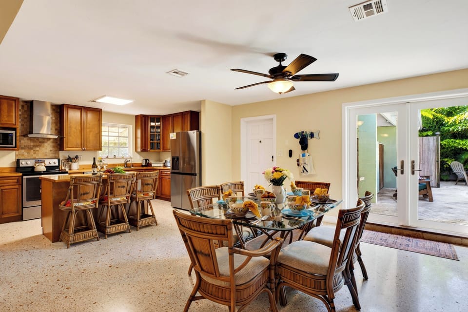 Gather for meals in the open dining area, with island seating and easy access to the patio.