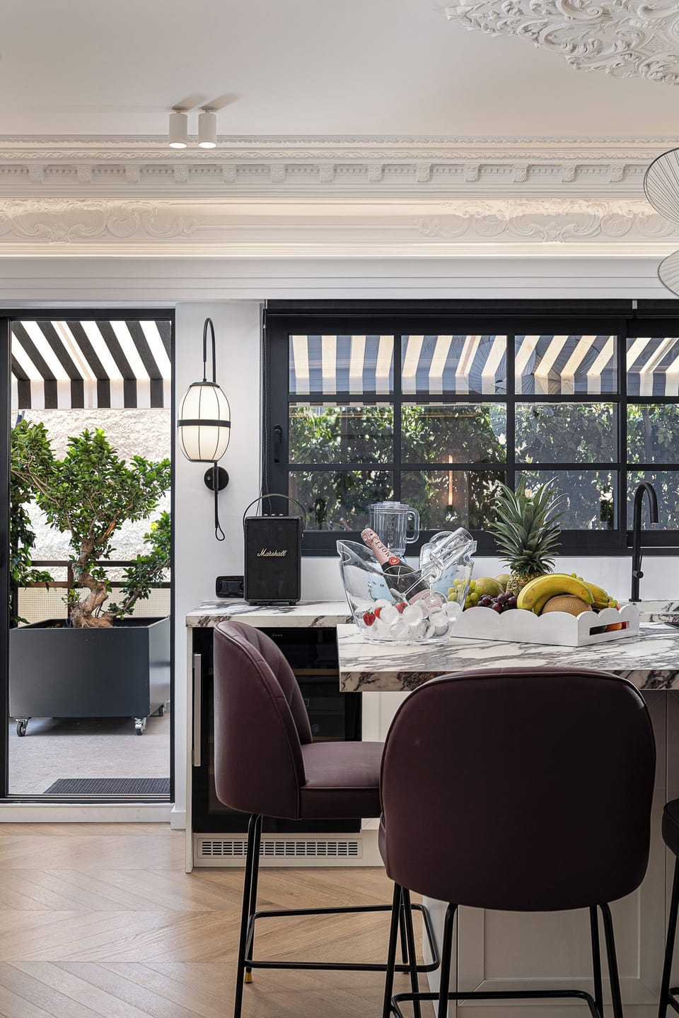 Fully equipped designer kitchen with Jura coffee machine, Neff wine cooler, LG double fridge, and breakfast bar for six—perfect for premium stays in the heart of Athens.