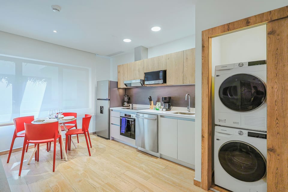 You'll love the convenience of your own full kitchen and in-unit laundry, perfect for longer stays. Bright dining area invites relaxed meals with natural light streaming in.