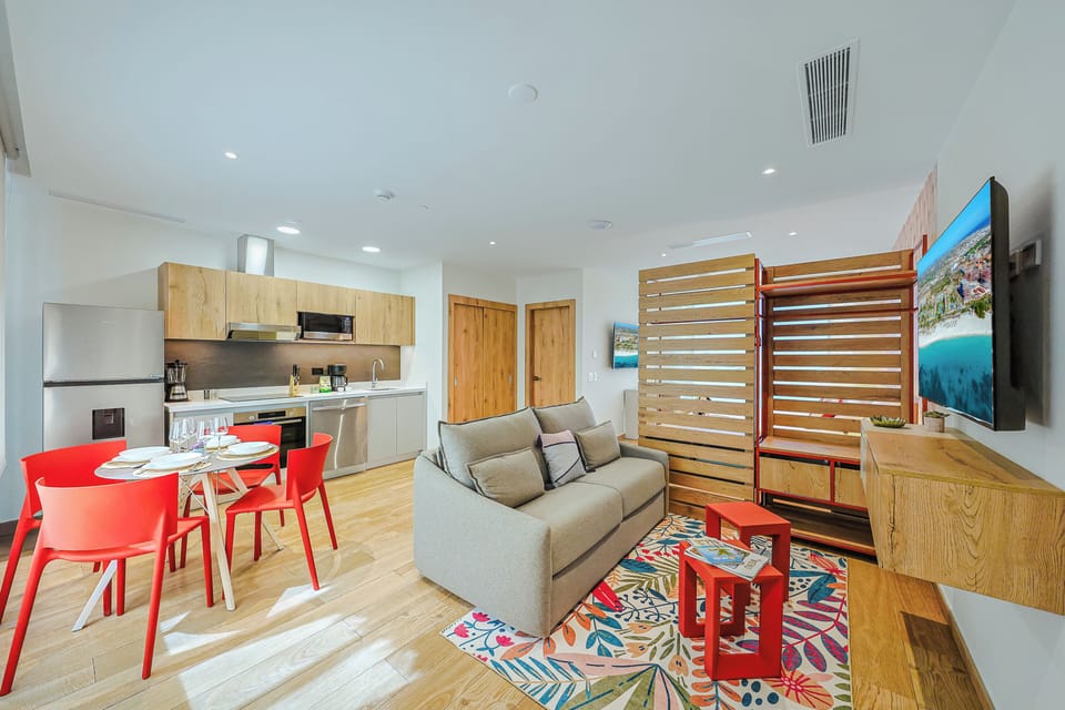 Your bright, open-plan space blends living, dining, and cooking seamlessly, with warm wood tones and playful pops of color welcoming you home after each adventure.