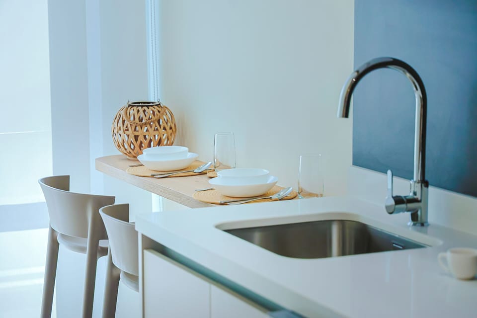 Your sleek kitchenette awaits, with a stainless steel sink, modern fixtures, and everything set for effortless meal prep in a bright, stylish space.