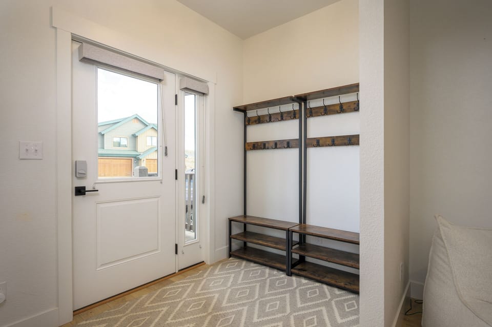 Step through your private entrance into a bright, organized mudroom designed for easy arrivals and departures, with built-in storage benches and hooks to keep your gear perfectly organized.