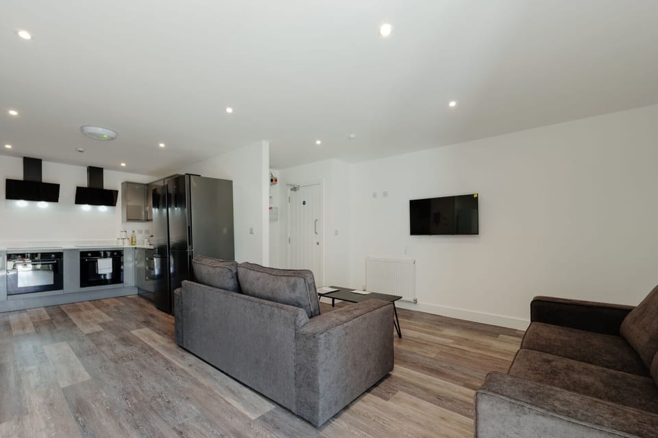 The open plan kitchen & living room features comfortable sofas and a smart TV