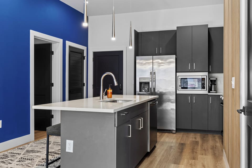 Sleek kitchen with quartz counters and premium appliances