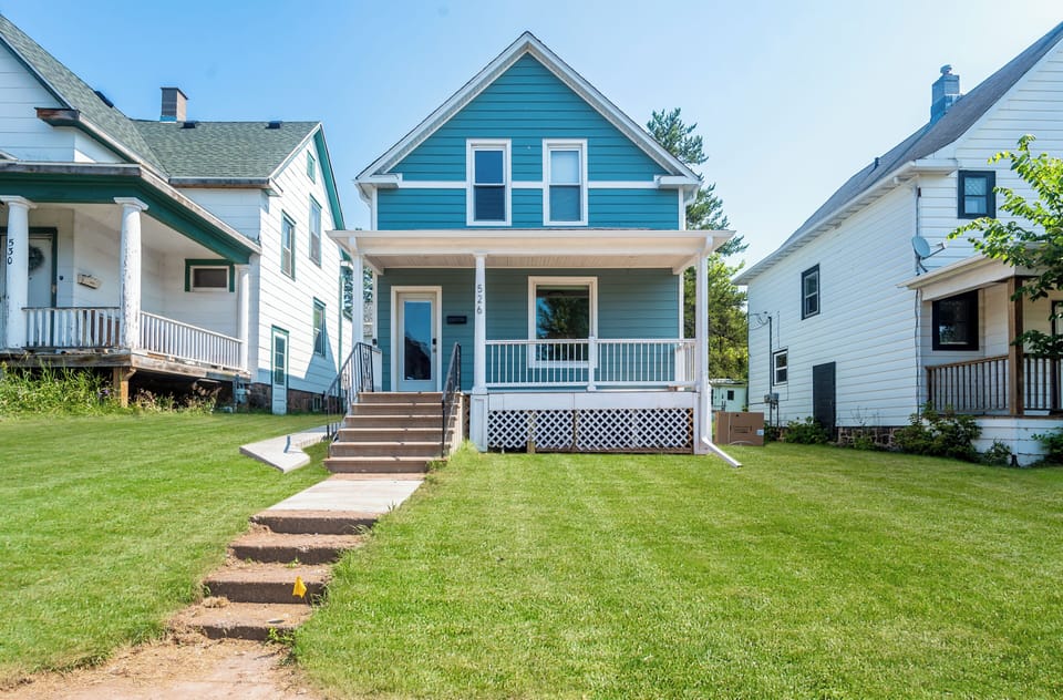 Restored 1908 Victorian with a covered front porch near Lake Superior.