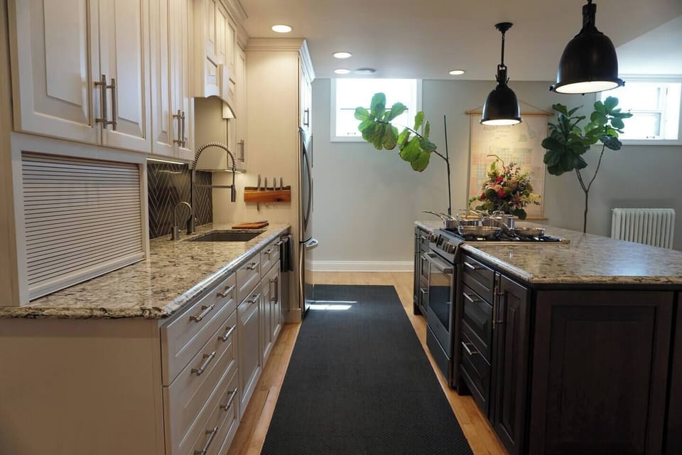 Large kitchen with wonderful natural light. We keep an abundance of fiddle leaf fig trees which love the high ceilings.