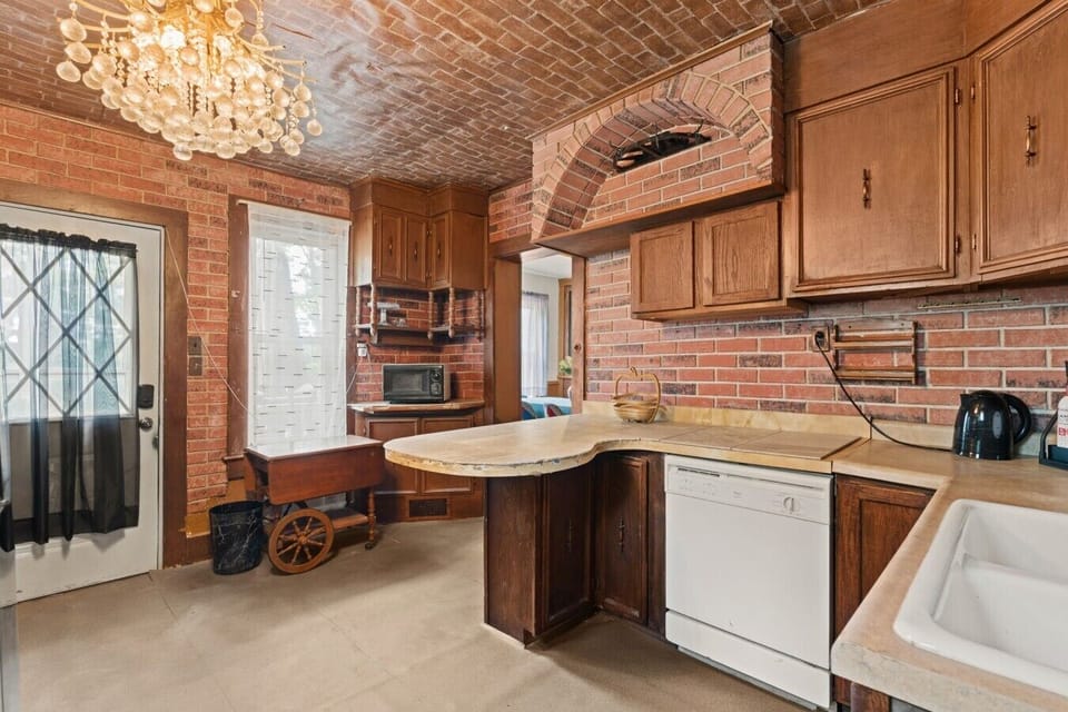 Kitchen | Brick Accent Walls | Chandelier Lighting