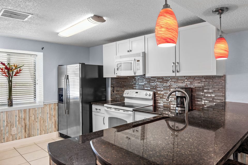 Kitchen. Natural light. Laundry room located in the kitchen including a washer and dryer machine.