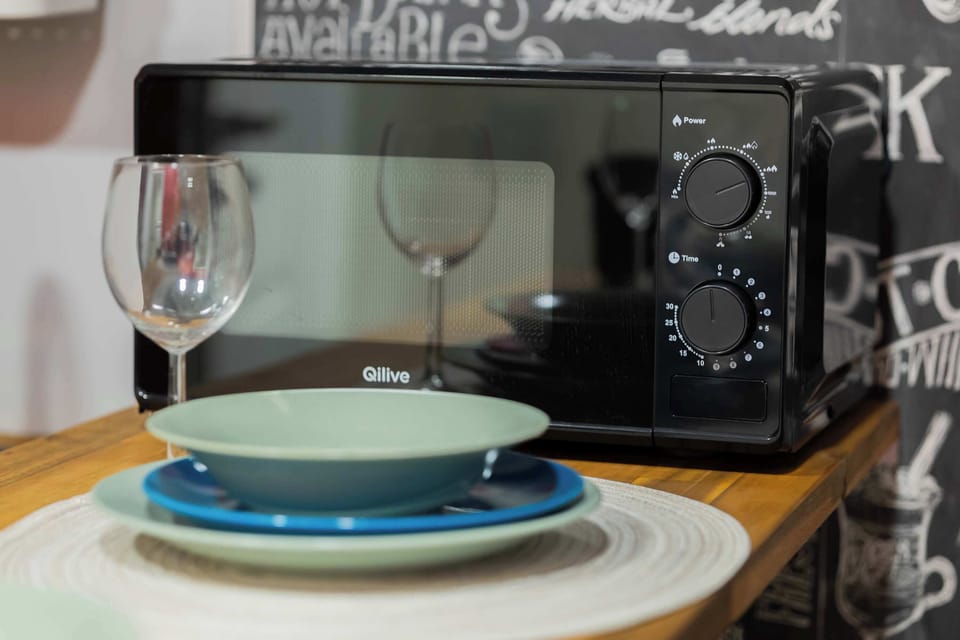 Dining table set with plates, bowls, glasses, and cutlery, creating an inviting atmosphere.