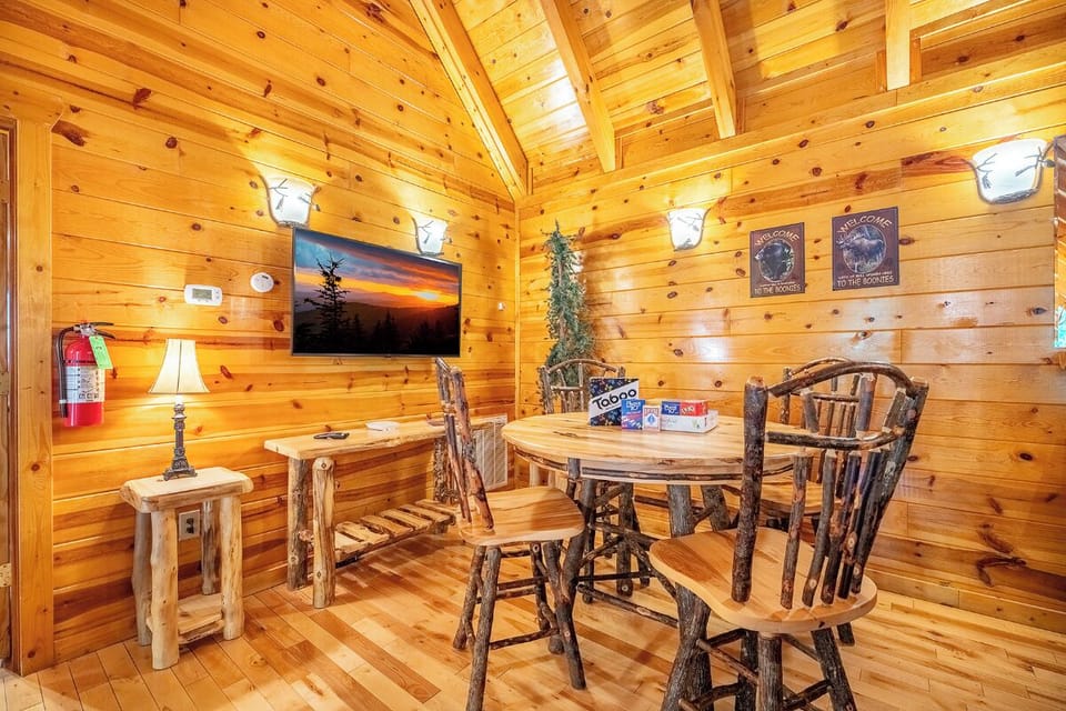 Gather around the handcrafted log table in this cozy cabin retreat, where rustic charm meets mountain comfort. The warm wood paneling and vaulted ceilings create your perfect escape for game nights and quality time together.