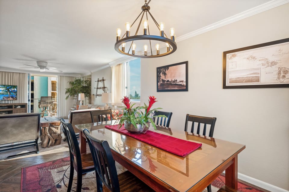 Gather around this elegant dining table for memorable meals with your group, lit by a striking chandelier and open to the bright, airy living spaces beyond.