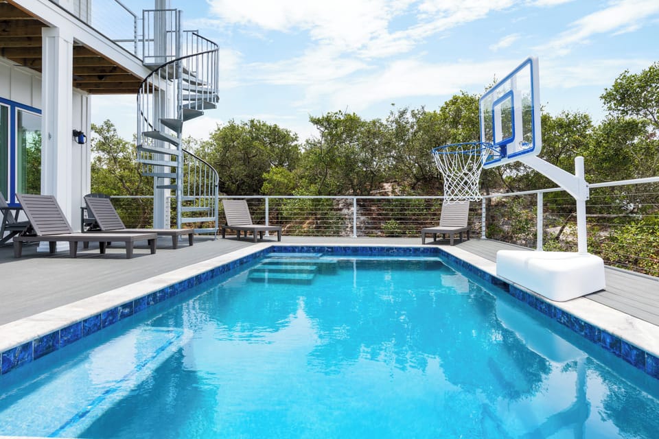 The sparkling blue pool can be heated or cooled to enjoy all year long!