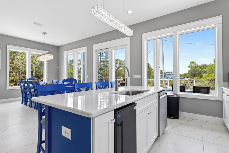 The kitchen is open to the living and dining rooms, and also has a view of the pool.  The entire main level also boasts 10-foot ceilings.
