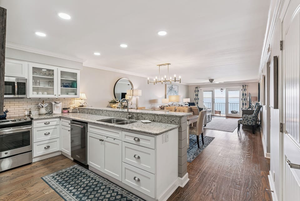 Your gourmet kitchen features granite countertops, stainless steel appliances, and flows seamlessly into the bright living space with stunning ocean views.