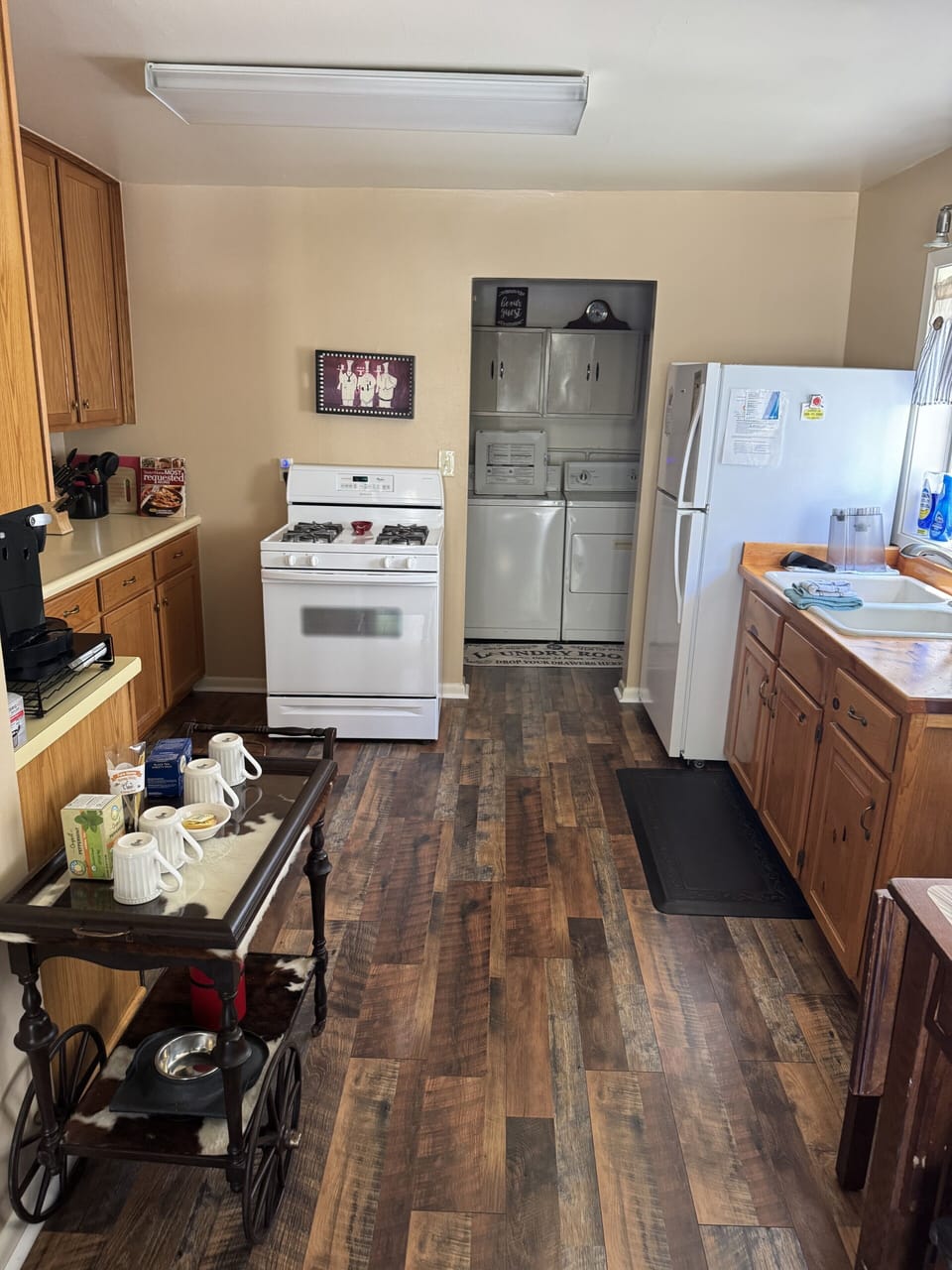 Cozy galley kitchen with full-size appliances and warm wood finishes