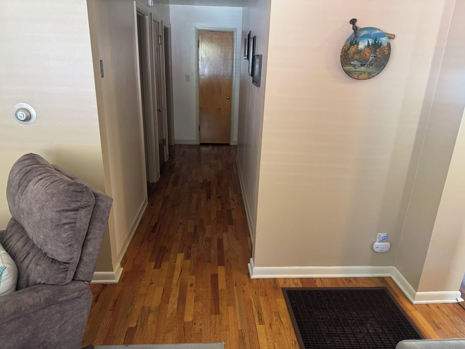 Warm hardwood hallway with clean lines and an inviting, homey feel