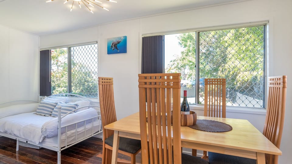 Cozy bedroom with tables and calming coastal décor.