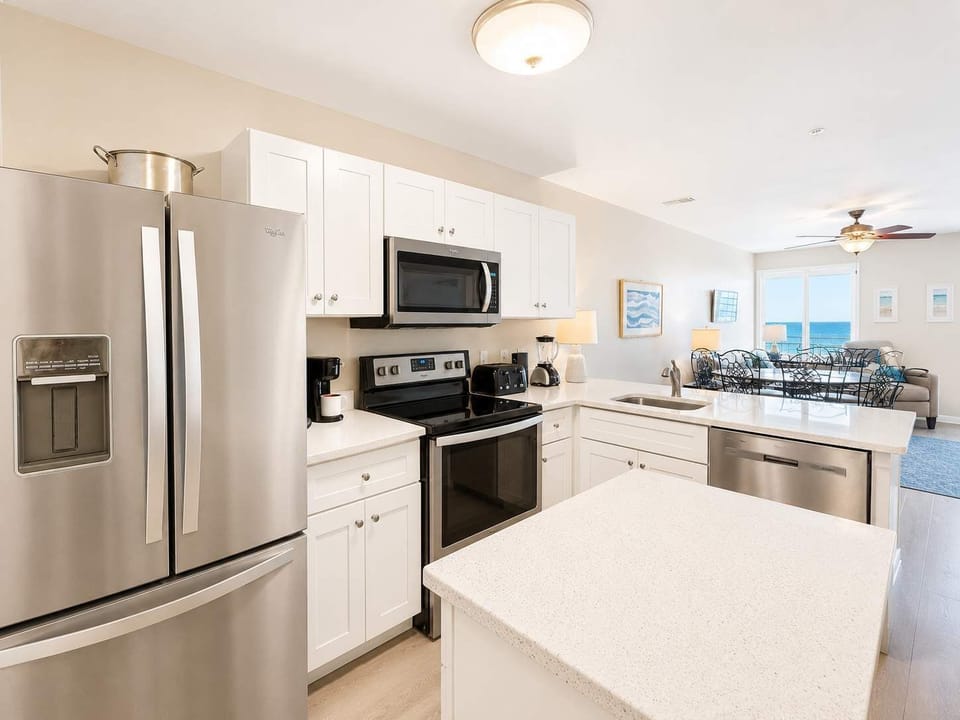 Well-equipped kitchen with stainless appliances & island 