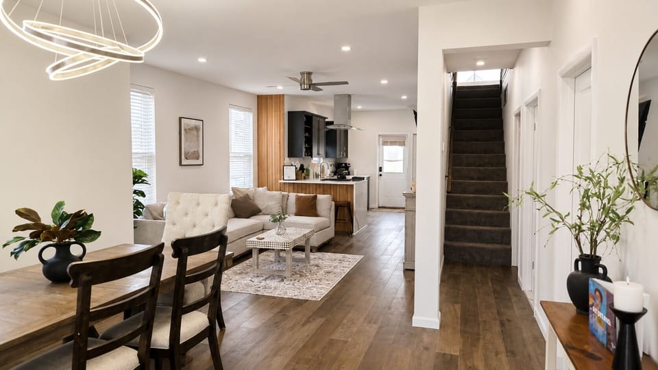 Bright open-concept living with modern kitchen, dining area, and cozy lounge