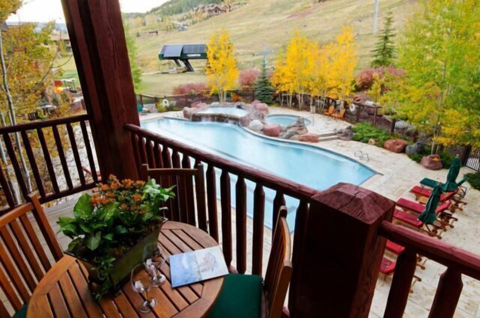 Private balcony with pool, hot tub, and scenic mountain-view setting