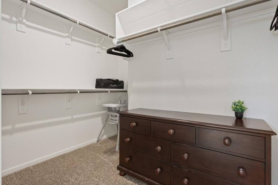 Primary Closet with towels and shampoo, conditioner, body wash
