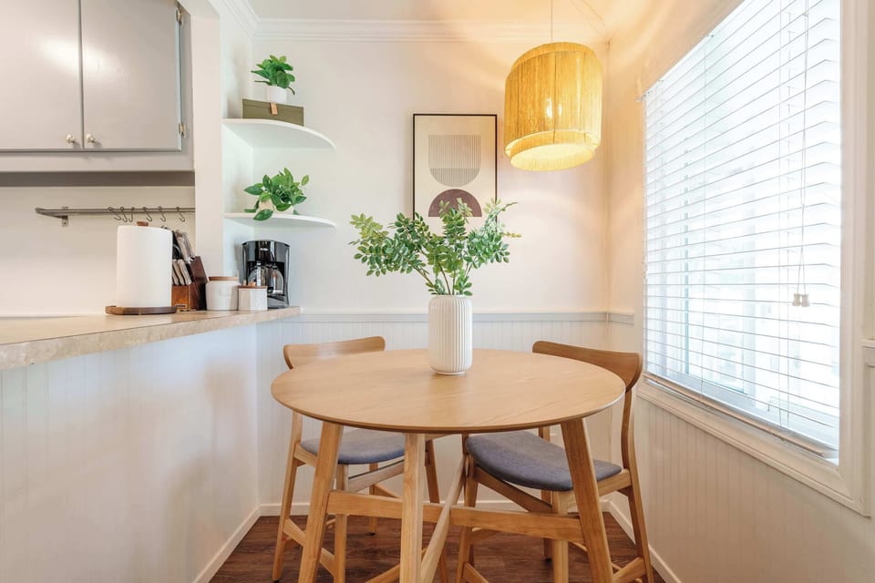 Cozy dining nook surrounded by natural light.
