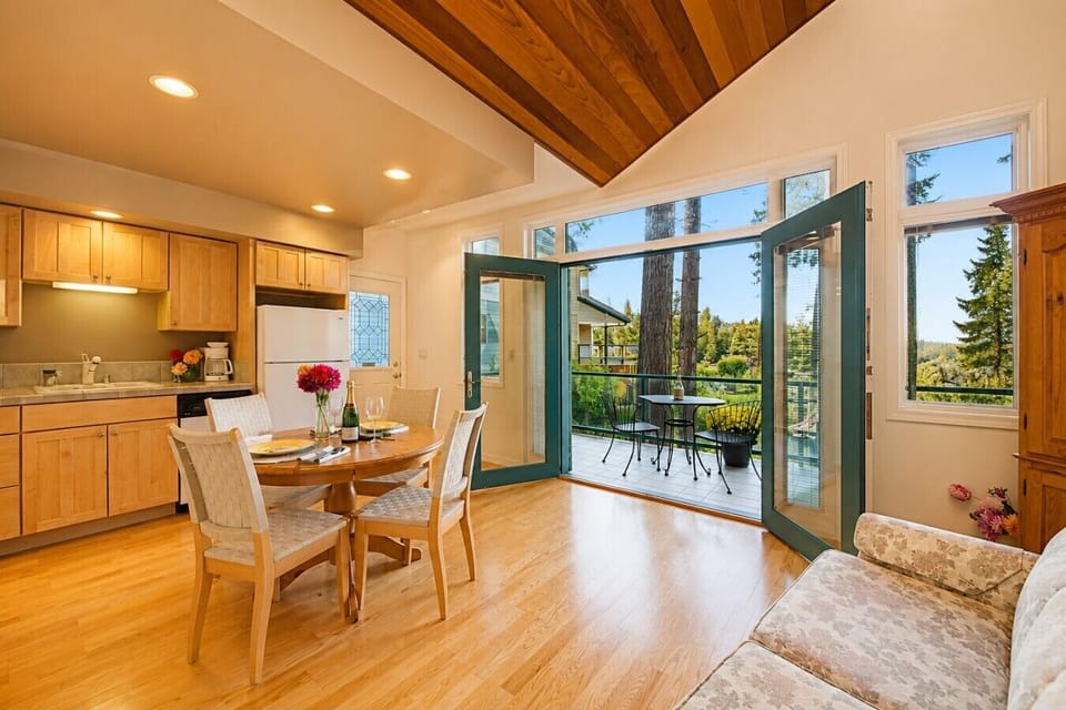 Open kitchen and dining with French doors to the view deck