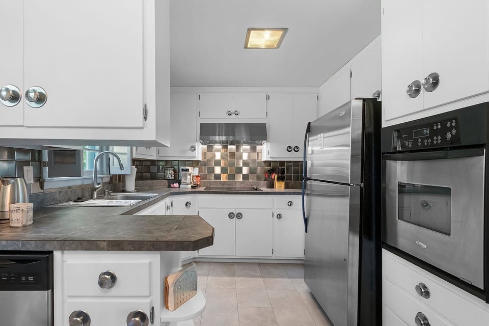 Bright modern kitchen with stainless steel appliances and ample workspace