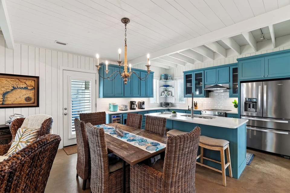 Kitchen and dining beneath a woven chandelier.