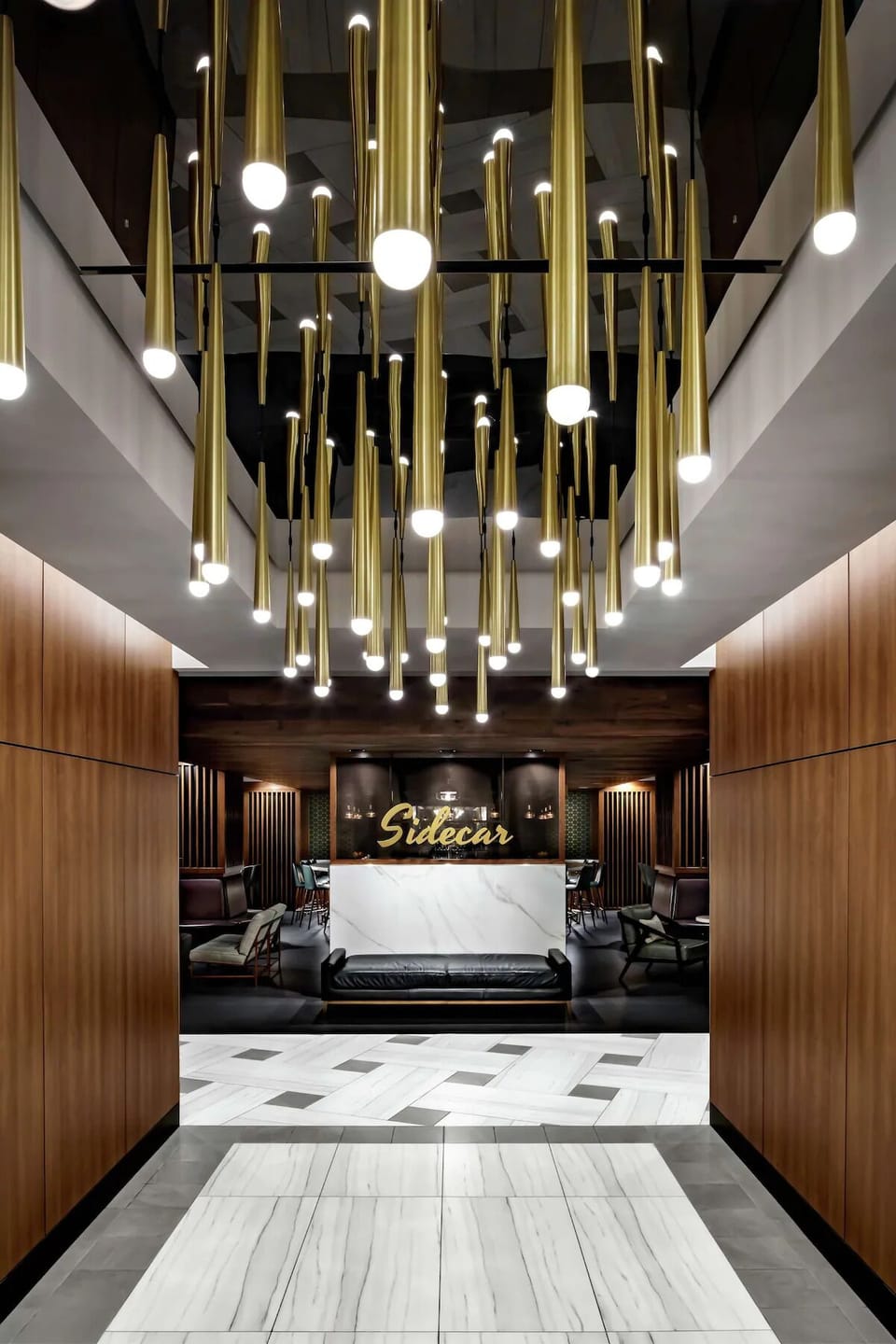Arrive in style through a glowing lobby with dramatic lighting.