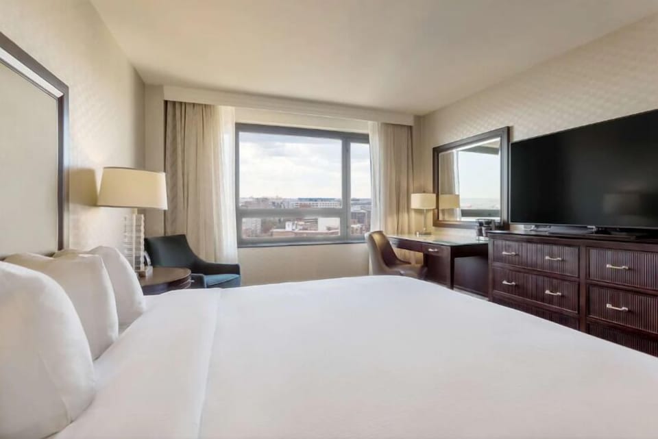 Wake up to airy city views from a plush bed.
