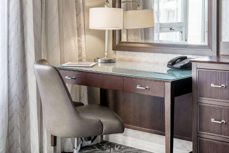 Catch up on emails at a sleek, well-lit workspace.