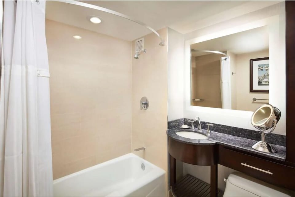 Refresh with a bright vanity and a relaxing shower-tub.