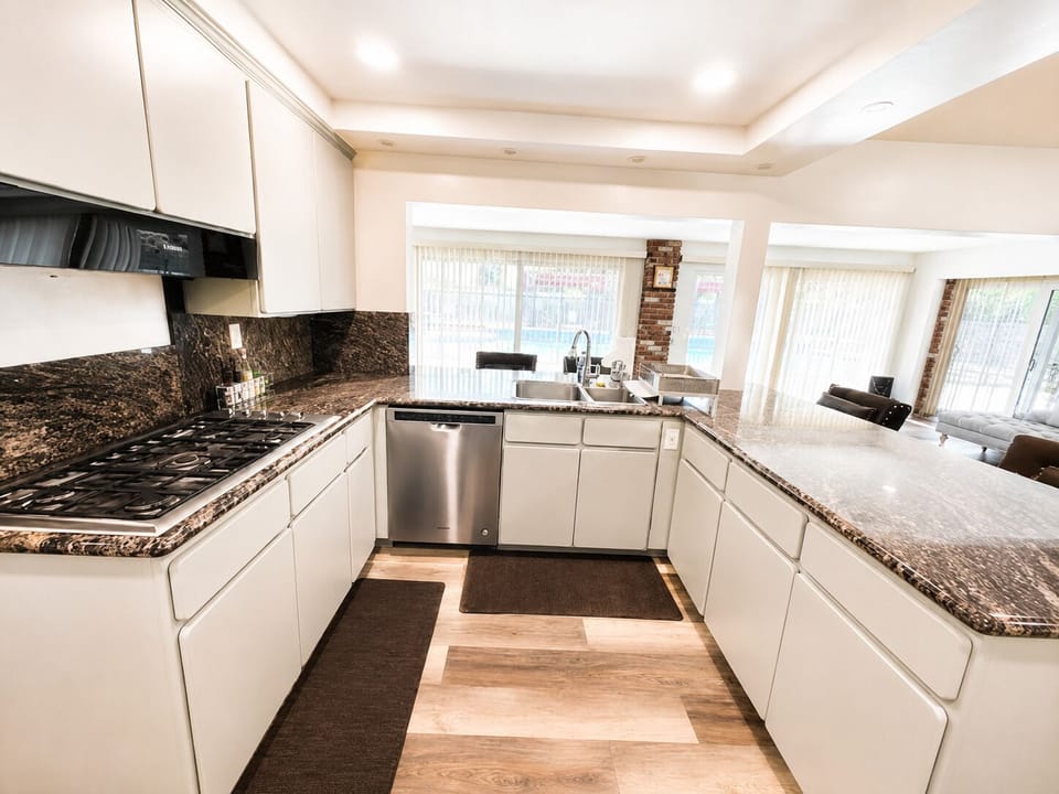 Bright open kitchen with granite counters, gas cooktop, and great natural light
