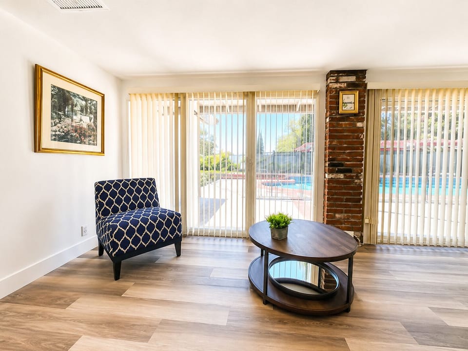 Bright lounge area with pool views and charming brick detail