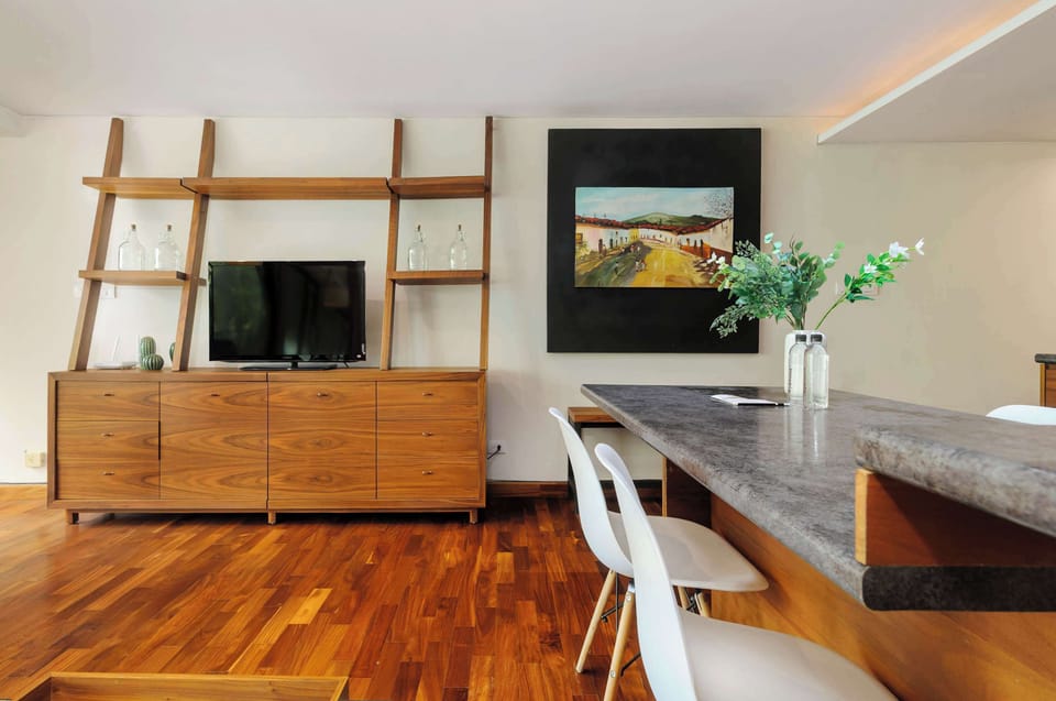 Stylish living room with a comfortable sofa, wooden shelving, and contemporary décor.
