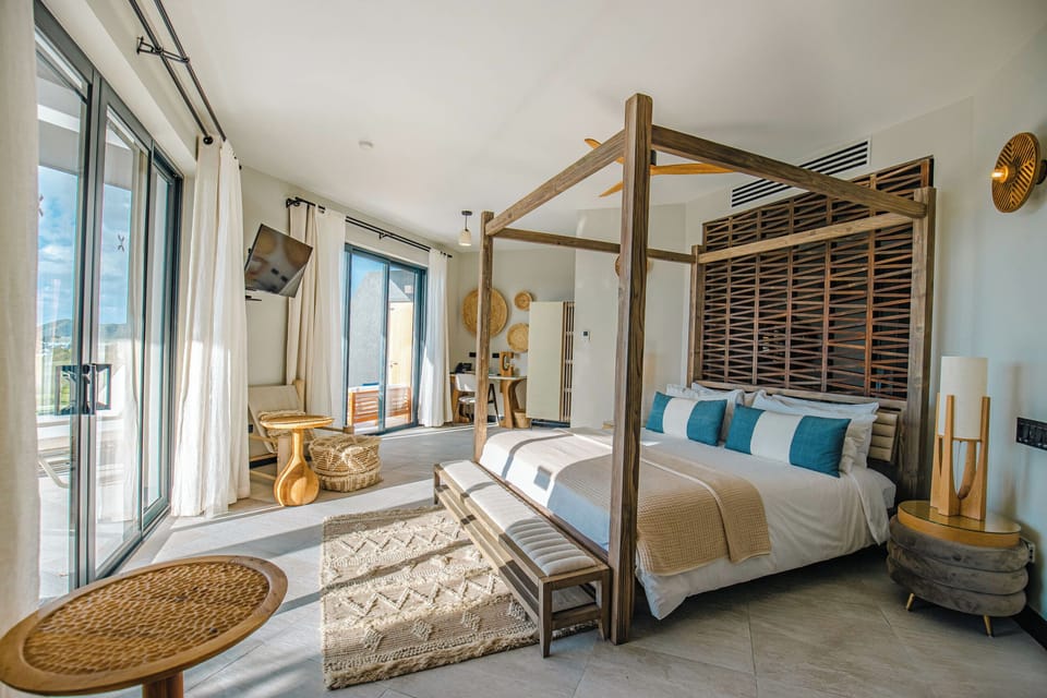 Unwind in a sunlit canopy bed with breezy island style.