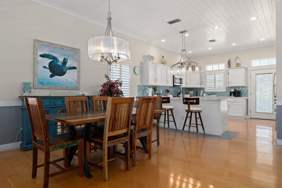 The dining area offers seating for  six at the main table, plus additional bar and bench seating.