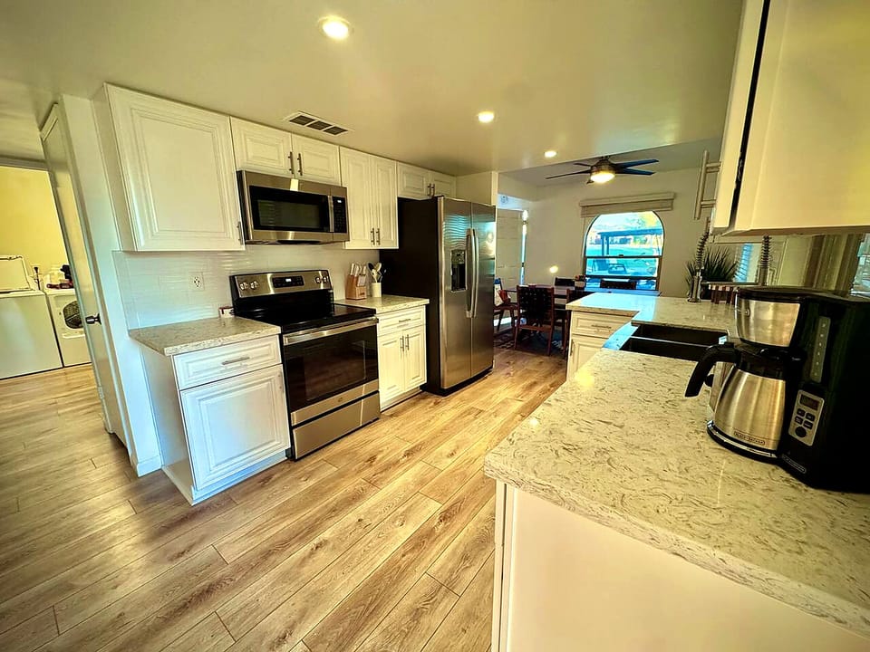 Bright modern kitchen with stainless appliances and open dining area