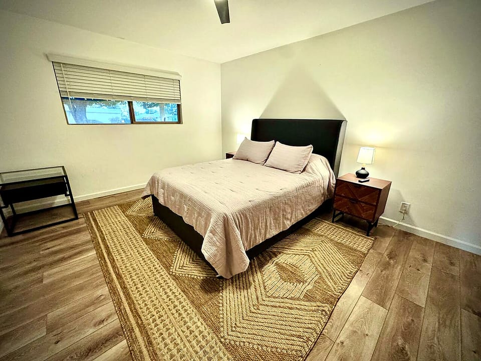 Cozy minimalist bedroom with warm lighting and spacious layout