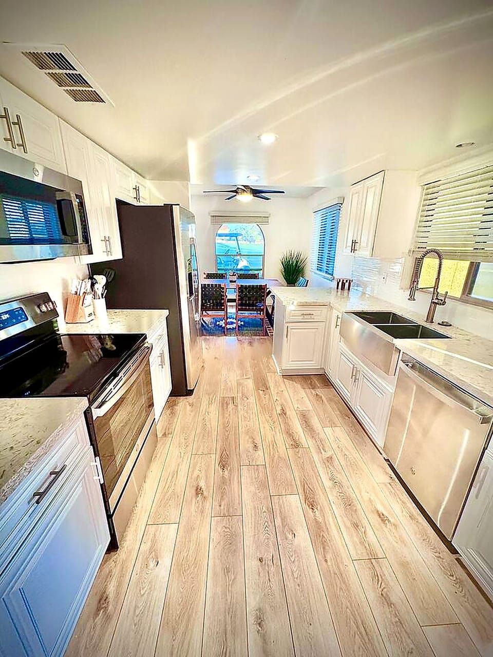 Bright modern kitchen with farmhouse sink and cozy dining nook